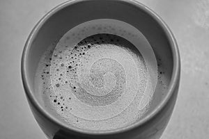 Black and white image ofÃ¢â¬â¹ hotÃ¢â¬â¹ coffeeÃ¢â¬â¹ inÃ¢â¬â¹ aÃ¢â¬â¹ ceramicÃ¢â¬â¹ cupÃ¢â¬â¹ with copy space. photo